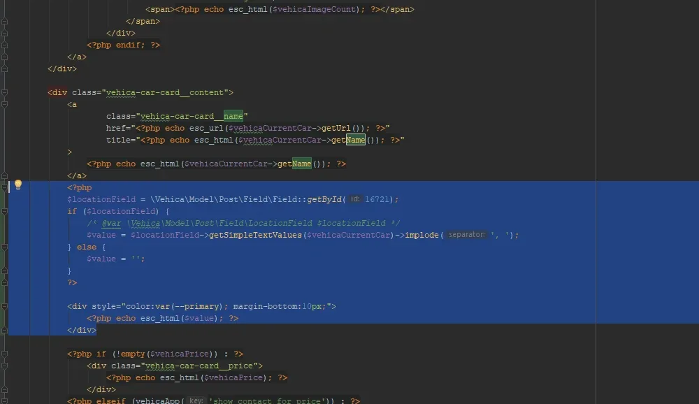 The card_v1.php template open in a code editor, with the location snippet highlighted and pasted just below the markup that outputs the card title link.