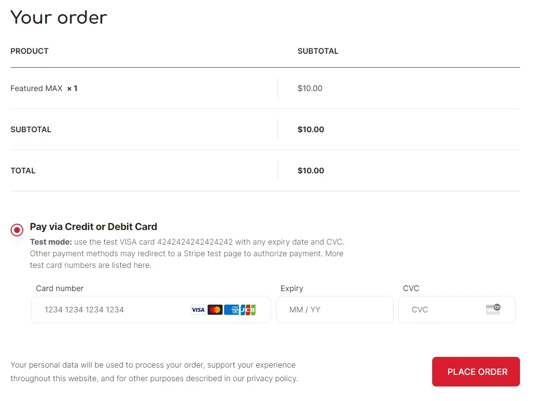 WooCommerce checkout "Your order" table showing Featured MAX × 1 with subtotal and total $10.00, and a "Pay via Credit or Debit Card" option in Stripe test mode with card number, expiry and CVC fields next to a "Place order" button.