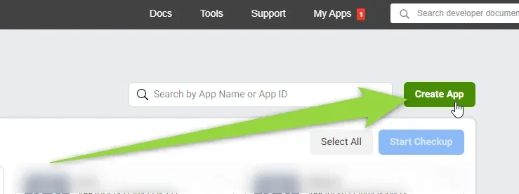 The Facebook for Developers My Apps page with a search box for app name or ID and a green Create App button. A large green arrow points at Create App; the app list below is blurred.